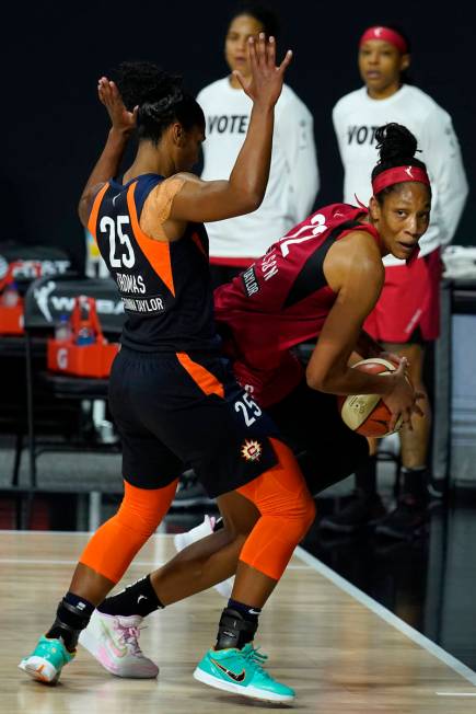 Connecticut Sun forward Alyssa Thomas (25) forces Las Vegas Aces center A'ja Wilson (22) out of ...