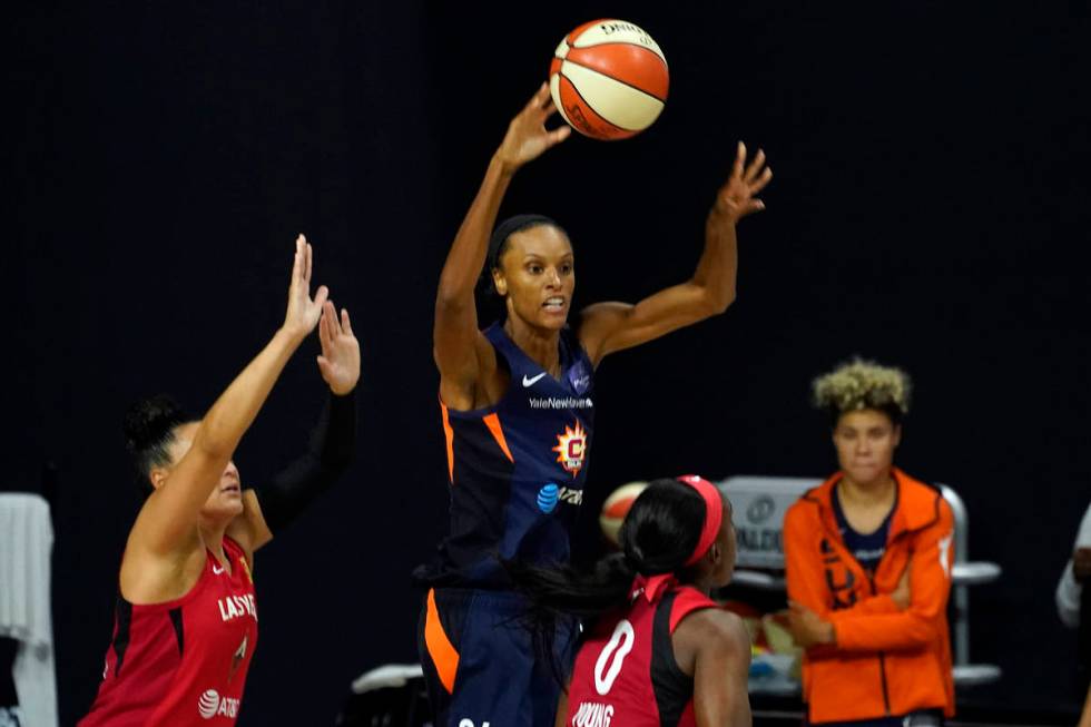 Connecticut Sun forward DeWanna Bonner grabs a rebound over Las Vegas Aces guard Kayla McBride ...