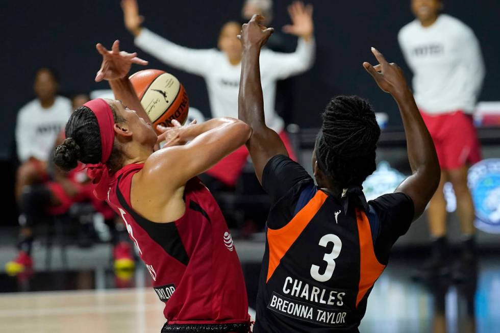 Las Vegas Aces forward Dearica Hamby (5) strips the ball from Connecticut Sun guard Kaila Charl ...