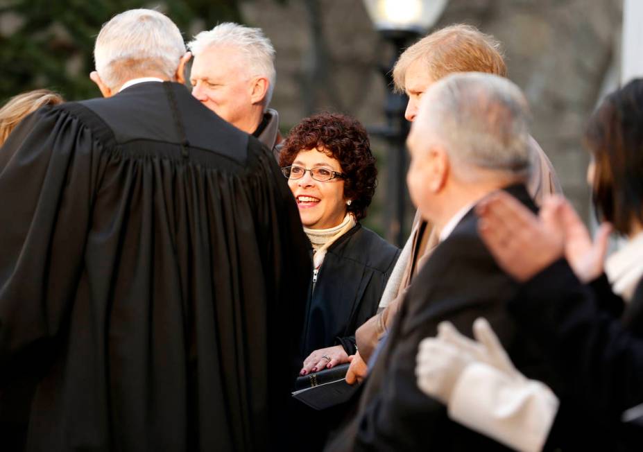 Nevada Supreme Court Chief Justice James Hardesty congratulates Justice Elissa Cadish, center, ...