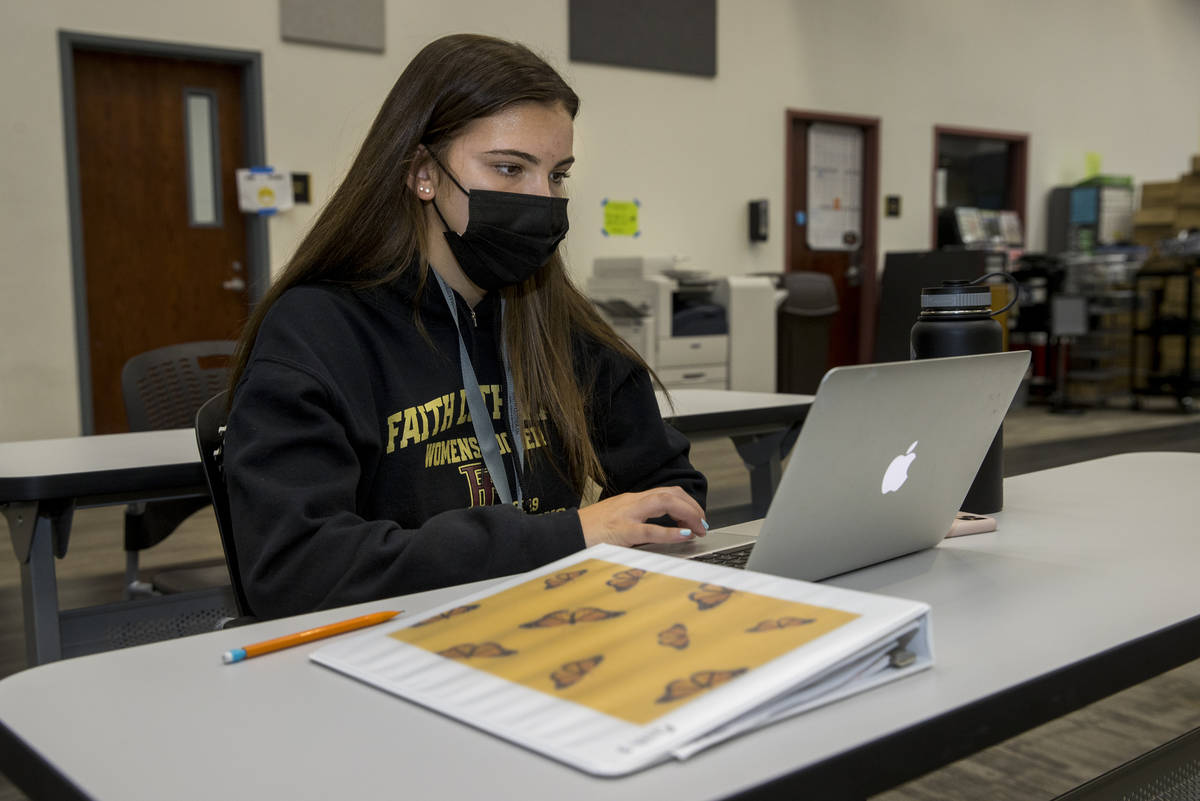 Student Tatum Bowers studies in the library with mask and social distancing at Faith Lutheran M ...