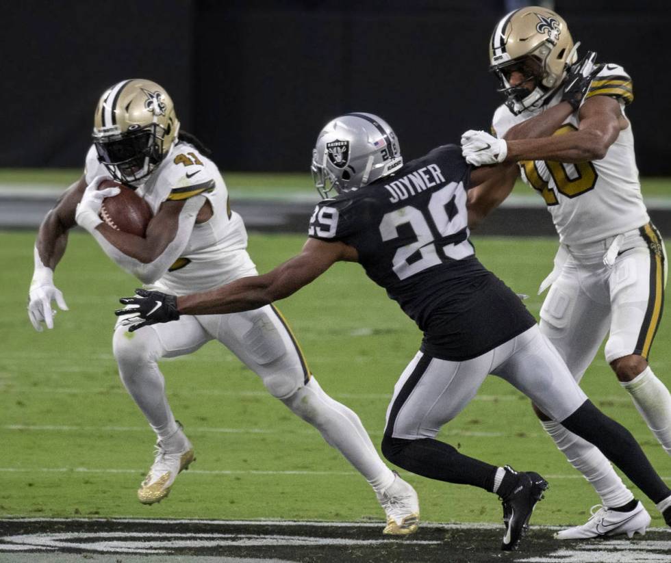 New Orleans Saints running back Alvin Kamara (41) cuts up field past Las Vegas Raiders free saf ...