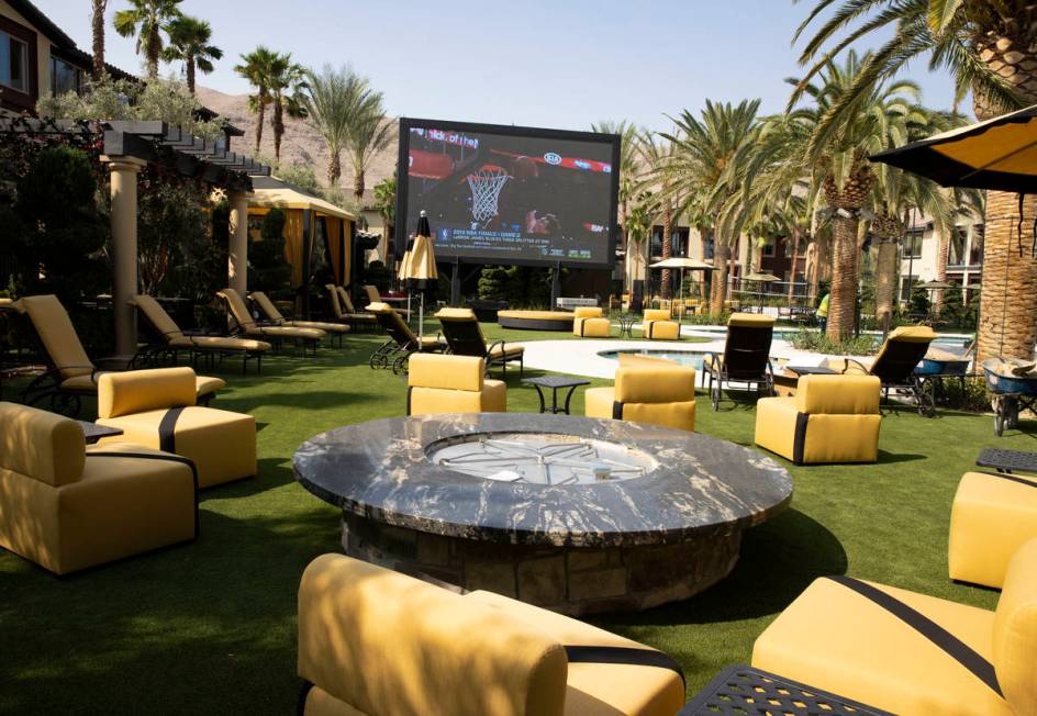 A fire pit and a giant television are seen at a pool area at the Tuscan Highlands apartment com ...