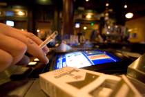 A smoker at a video poker machine in Las Vegas. (K.M. Cannon/Las Vegas Review-Journal)