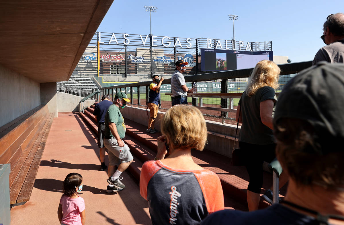 Fans check out the visitor dugout during a tour of Las Vegas Ballpark in Summerlin Friday, Sept ...