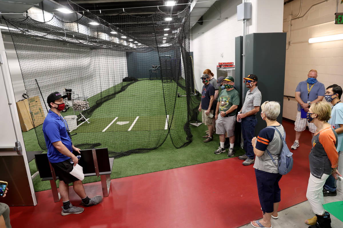 Nathan Erbach, left, Las Vegas Aviators account executive, shows the home batting cage during a ...