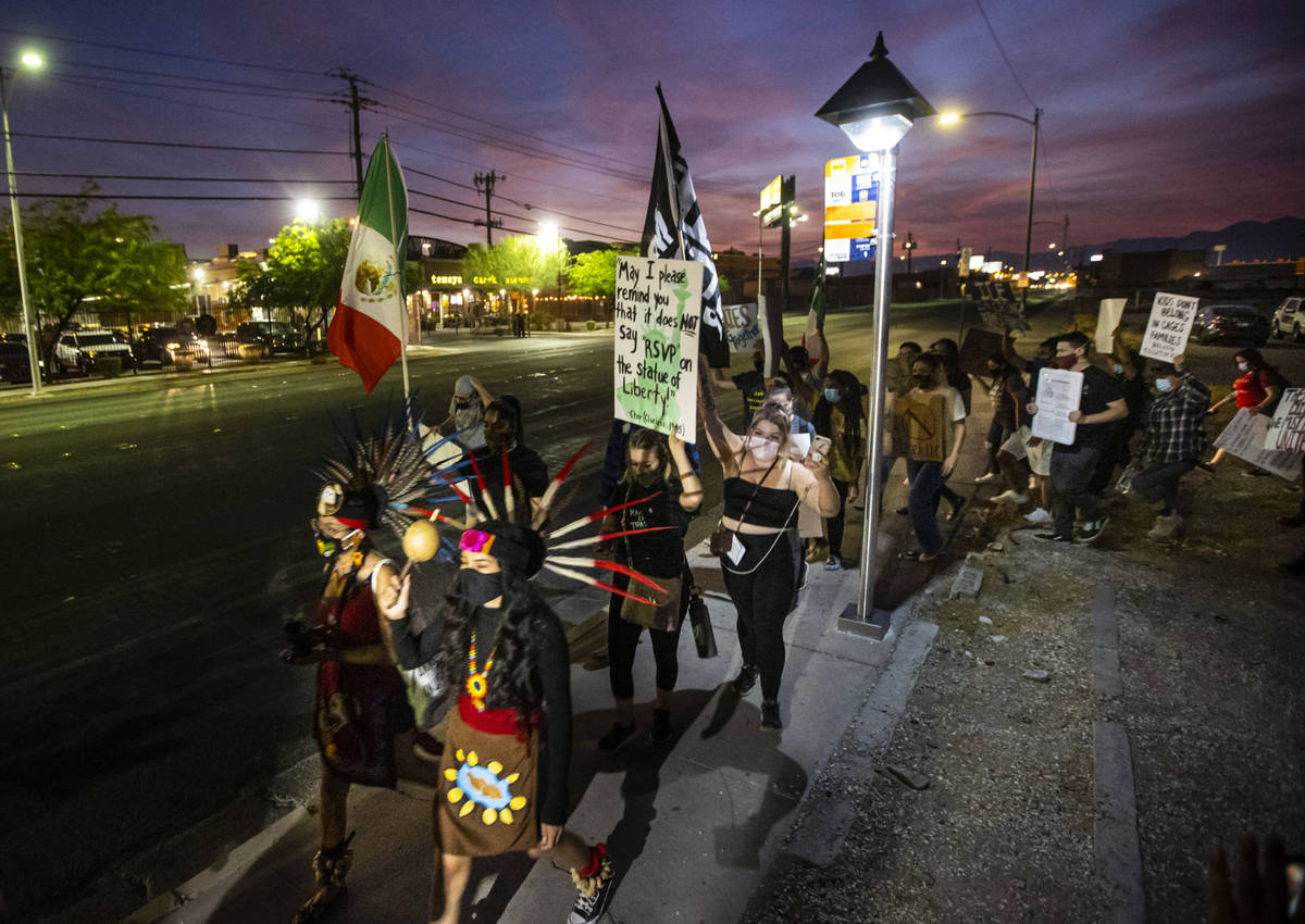 People march down Bonanza Road during a protest against U.S. Immigration and Customs Enforcemen ...