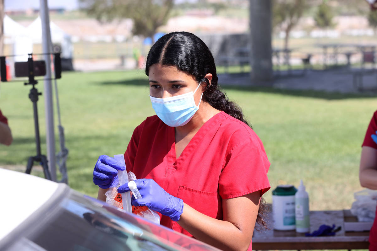 Registered nurse Liliana Sandoval explains a self-administered COVID-19 test to a patient at th ...