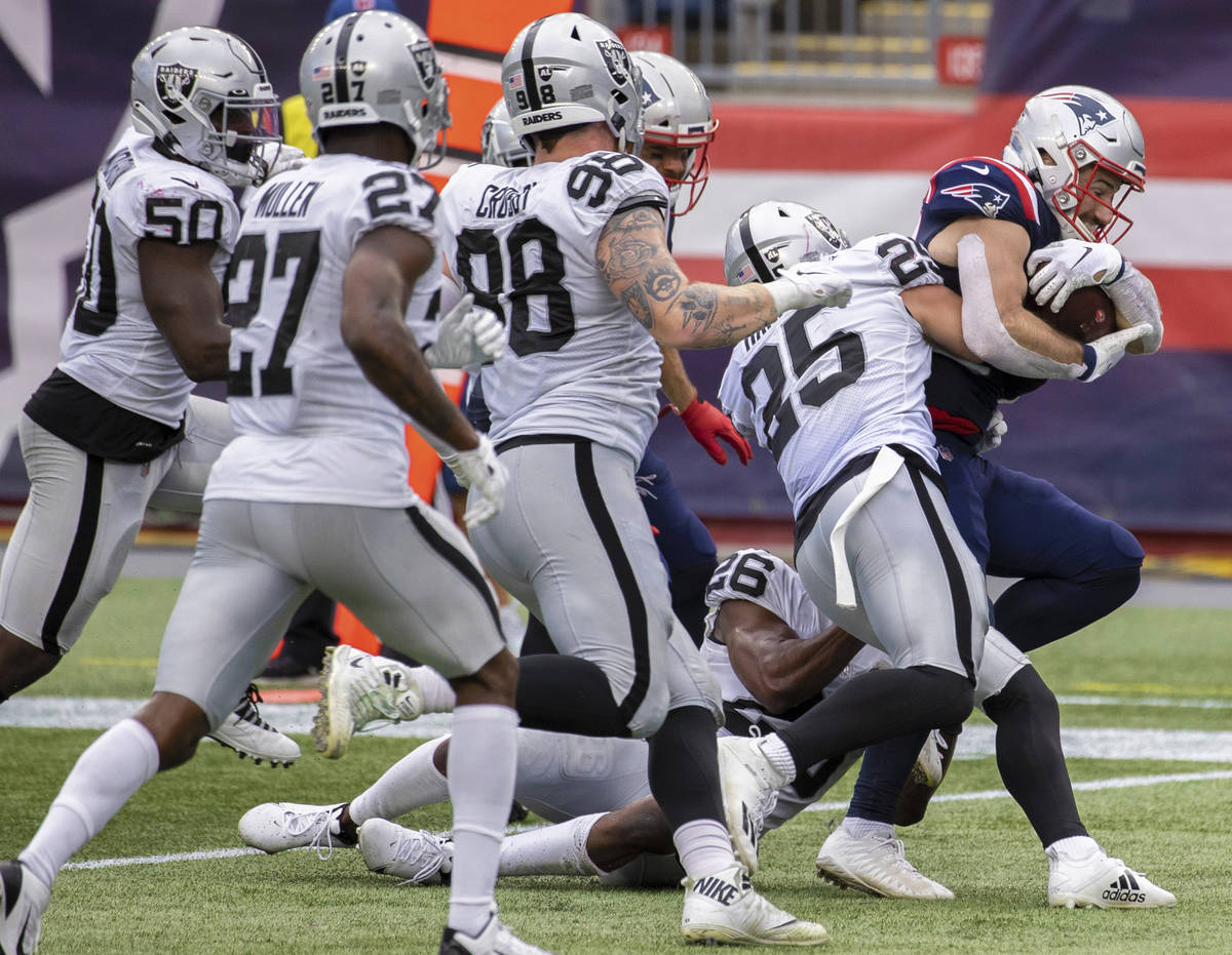 New England Patriots running back Rex Burkhead (34) fights for extra yardage against Las Vegas ...