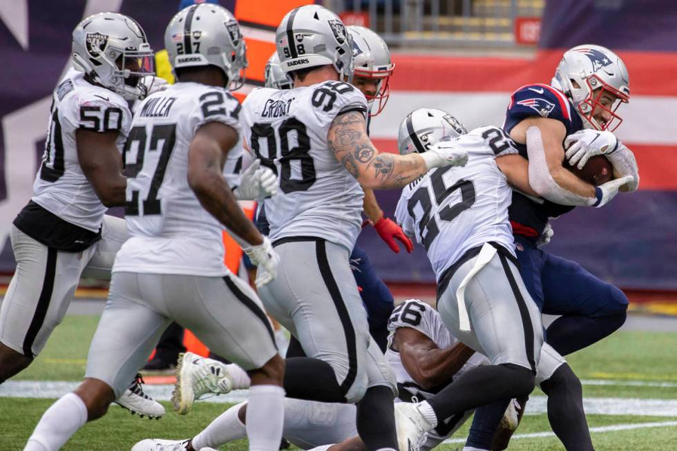 New England Patriots running back Rex Burkhead (34) fights for extra yardage against Las Vegas ...