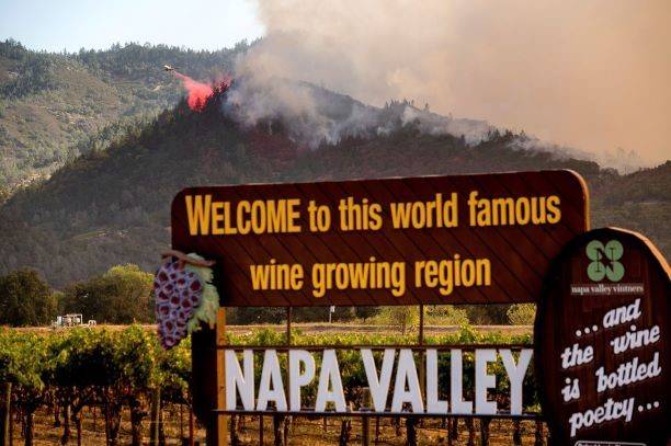 An air tanker drops retardant on the Glass Fire burning in Calistoga, Calif., on Sunday, Sept. ...