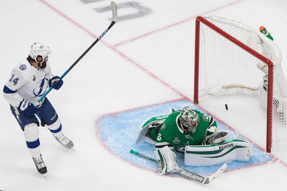 Tampa Bay Lightning's Pat Maroon (14) watches the puck go in past Dallas Stars goalie Anton Khu ...