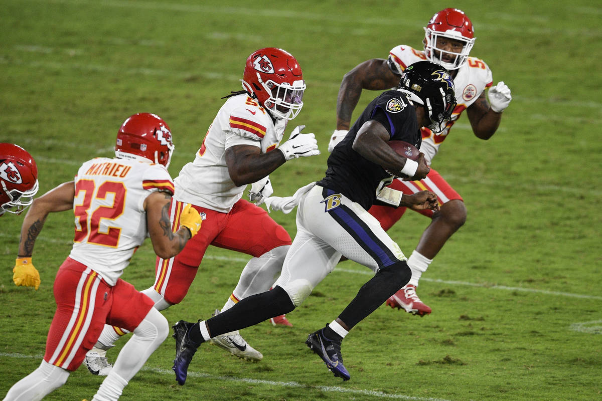Baltimore Ravens quarterback Lamar Jackson (8) scrambles as he is pursued by Kansas City Chiefs ...
