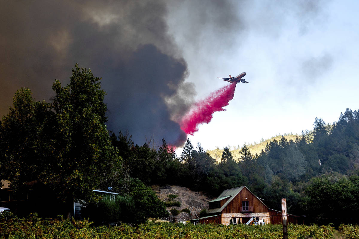 An air tanker drops retardant while battling the Glass Fire in St. Helena, Calif., on Sunday, S ...