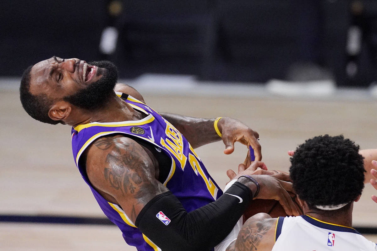 Los Angeles Lakers' LeBron James (23) falls backwards during a play in the second half of an NB ...