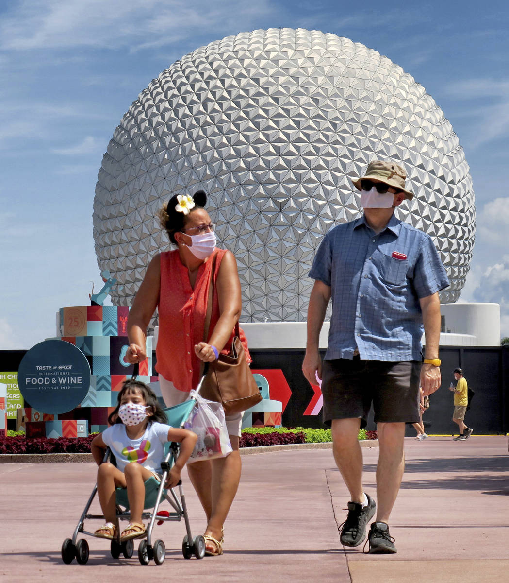 Guests arrive to attend the official re-opening day of Epcot at Walt Disney World in Lake Buena ...