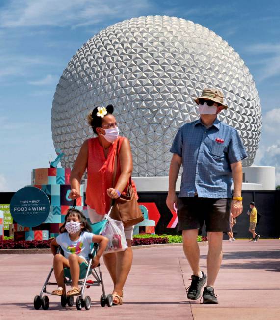 Guests arrive to attend the official re-opening day of Epcot at Walt Disney World in Lake Buena ...