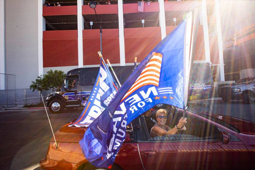 Lisa Schultz, of Las Vegas, waves a flag as supporters of law enforcement and President Donald ...