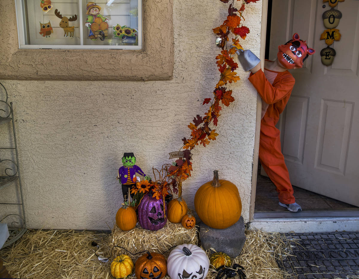 Alex Montenegro, 8, shows off his costume with the family home decorated for Halloween on Wedne ...