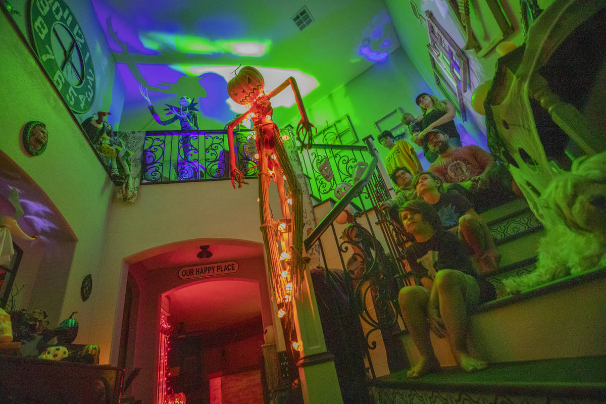 Tiffany and Leroy Garcia pose like ghosts with their sons in their entryway that is in the begi ...