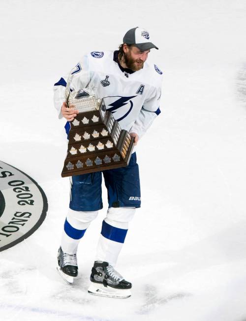 Tampa Bay Lightning defenseman Victor Hedman (77) carries the Conn Smythe Trophy after defeatin ...