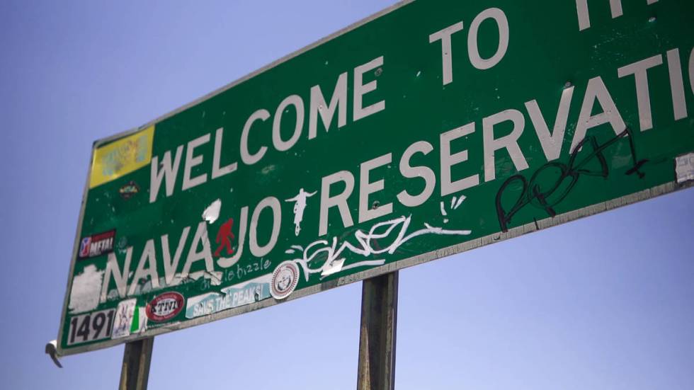 The Navajo reservation sign is covered in graffiti on July 30, 2020. One sticker reads, "Save T ...