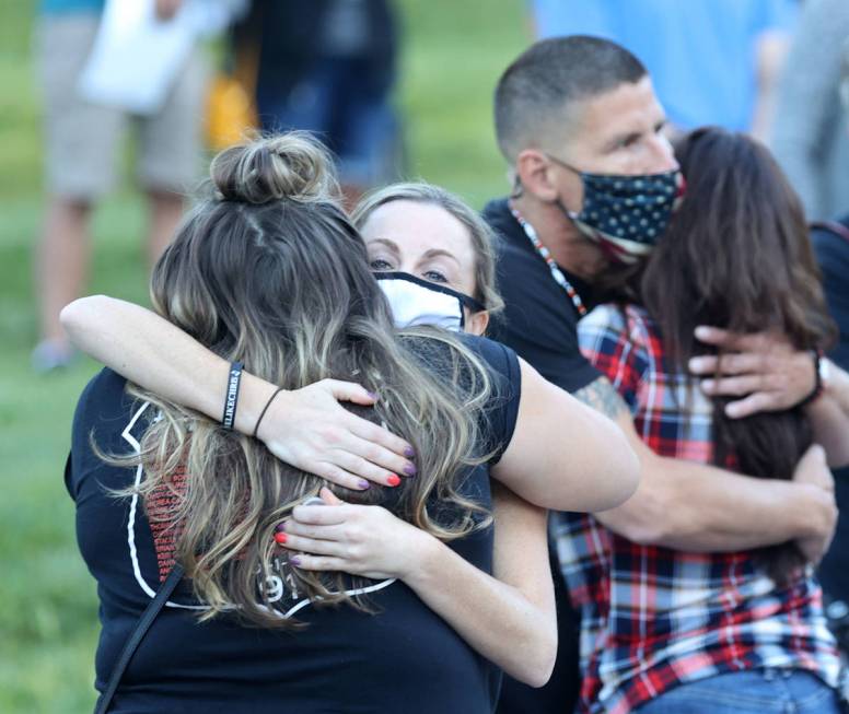 Survivors of the Route 91 Harvest festival shooting Kendal Kerbrat, of Las Vegas, left, hugs Ke ...