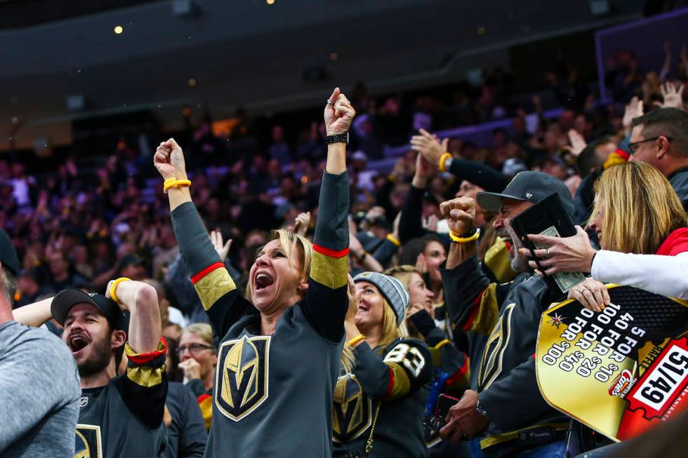 Golden Knights fans celebrate after a goal by Mark Stone during the first period of their NHL s ...