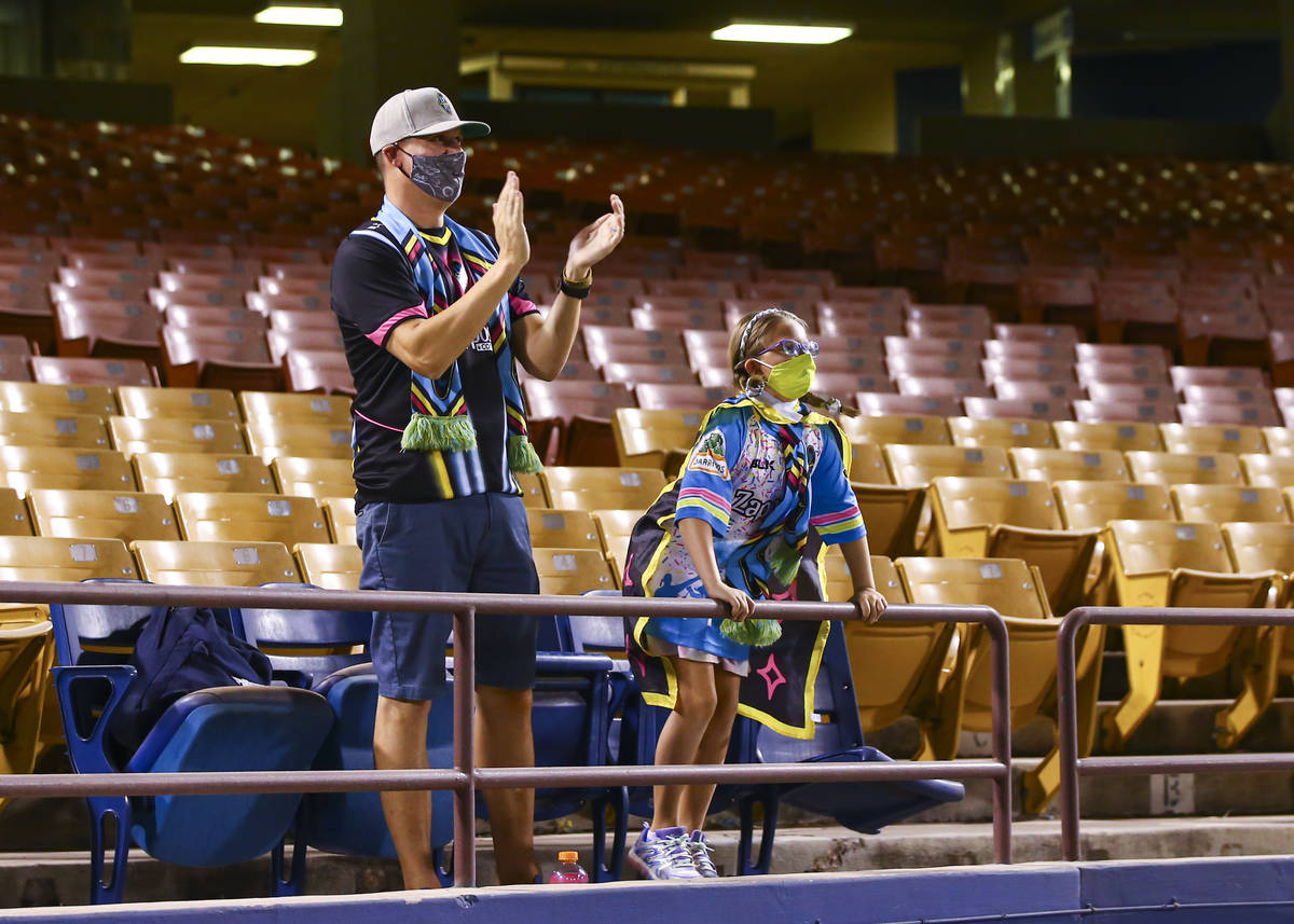 Las Vegas Lights FC fans Zac Moyle, left, with daughter Piper Moyle, 8, cheer at the start of a ...