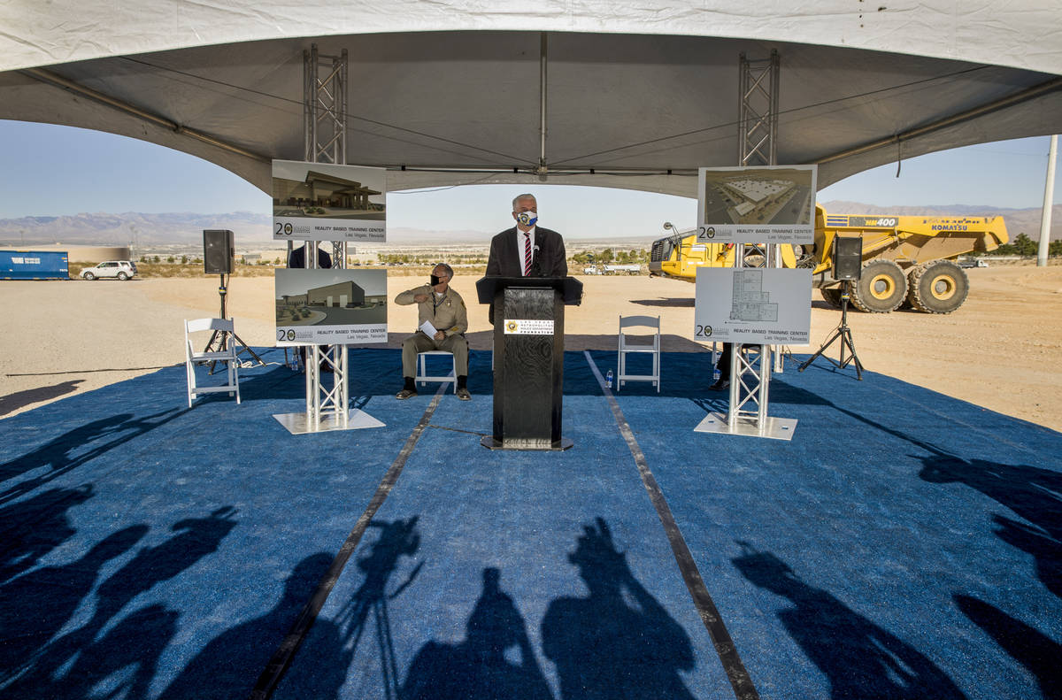 Governor Steve Sisolak, center, joined by Sheriff Joseph Lombardo, addresses those gathered dur ...