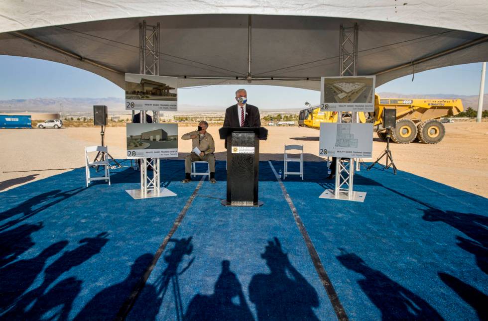 Governor Steve Sisolak, center, joined by Sheriff Joseph Lombardo, addresses those gathered dur ...