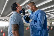 Clark County fireman Eddie Galaz, left, and combat medic Nevada National Guard Sgt. Steve Sanso ...