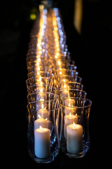 Candles are lit after the names of the victims of the Route 91 Harvest festival shooting were r ...