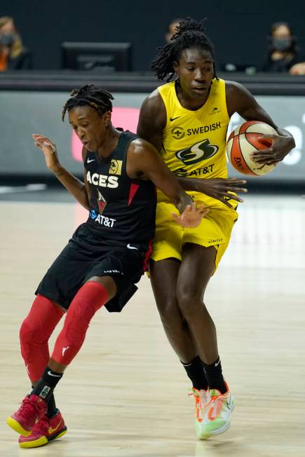 Seattle Storm forward Natasha Howard (6) and Las Vegas Aces guard Danielle Robinson (3) collide ...