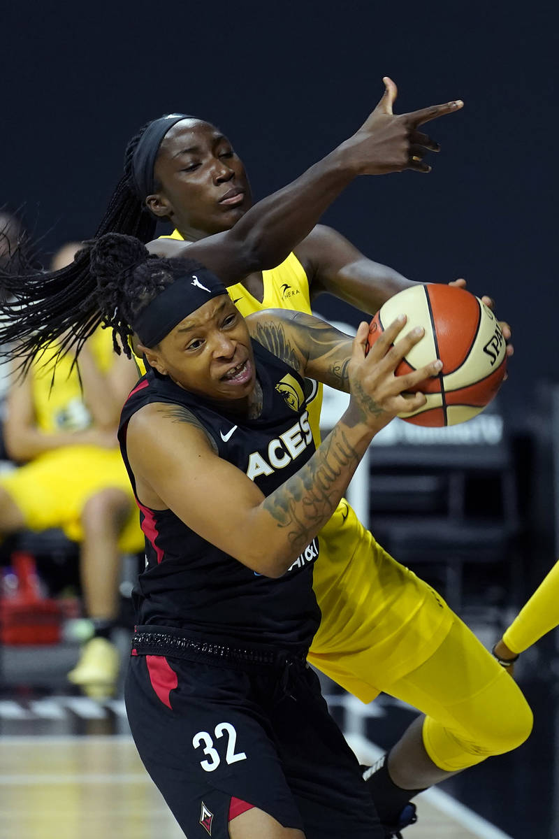 Las Vegas Aces forward Emma Cannon (32) grabs a rebound away from Seattle Storm center Ezi Magb ...