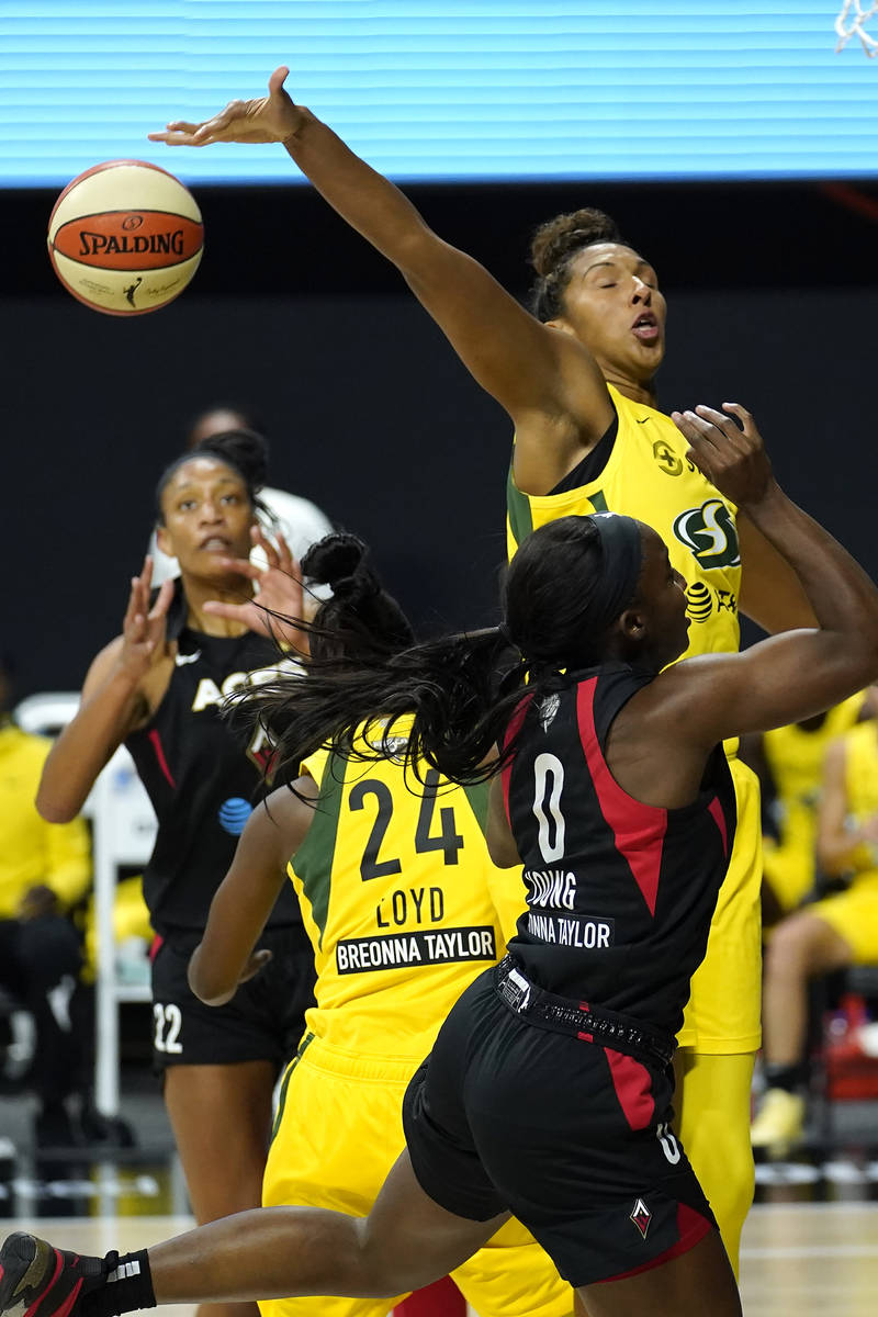 Seattle Storm center Mercedes Russell (2) blocks a shot by Las Vegas Aces guard Jackie Young (0 ...