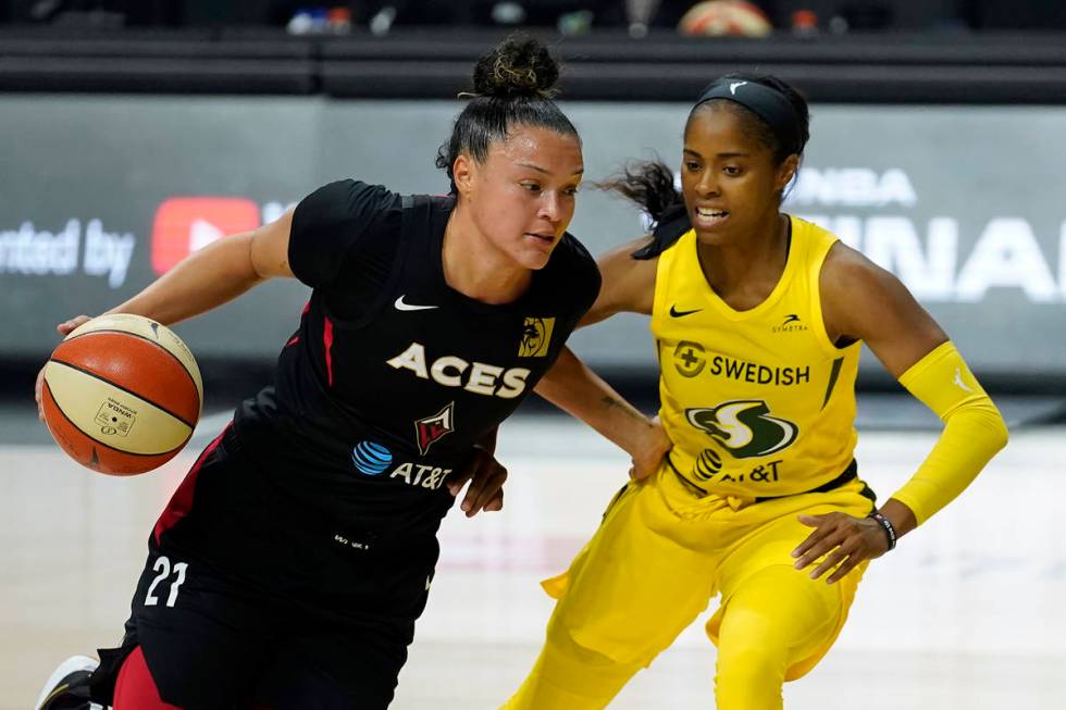 Las Vegas Aces guard Kayla McBride, left, drives around Seattle Storm guard Jordin Canada durin ...