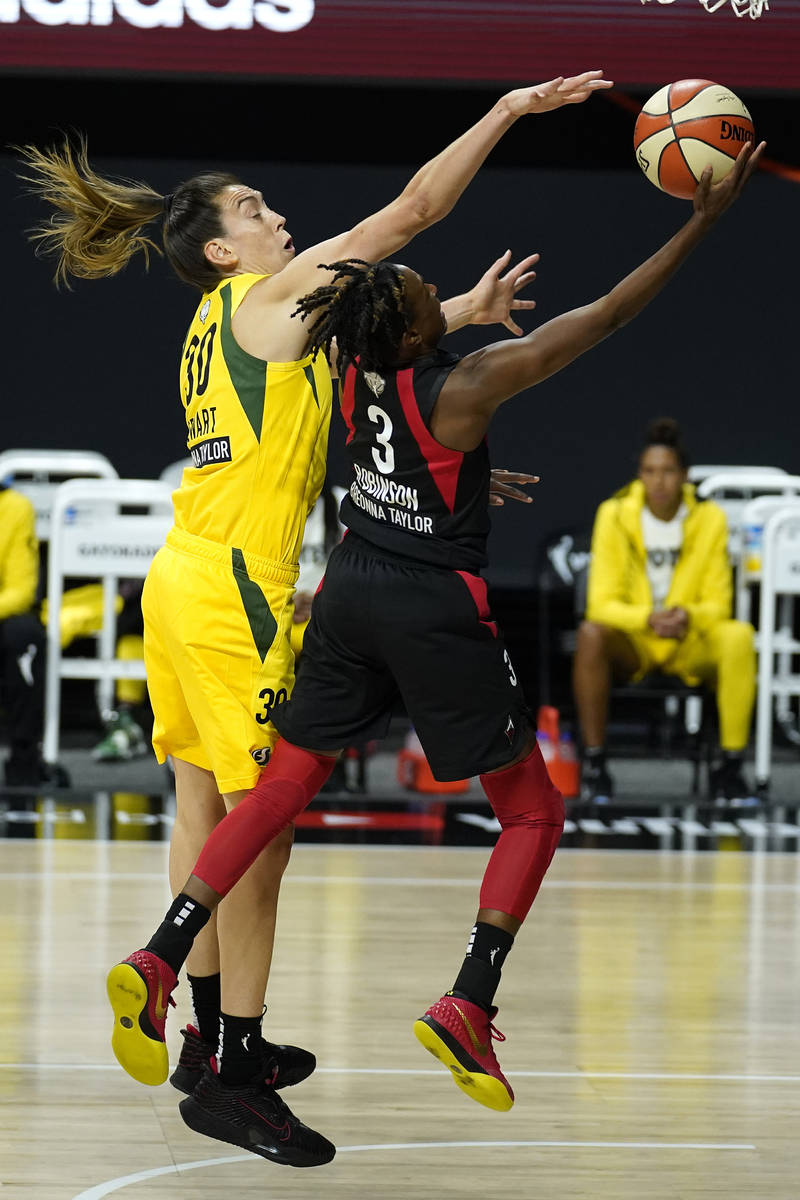 Las Vegas Aces guard Danielle Robinson (3) shoots as she is guarded by Seattle Storm forward Br ...