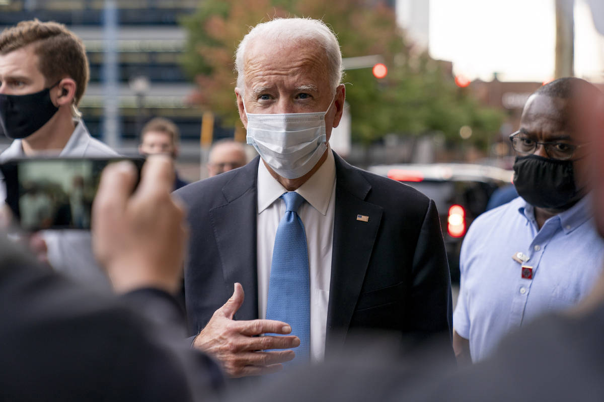 Democratic presidential candidate former Vice President Joe Biden stops to speak to members of ...