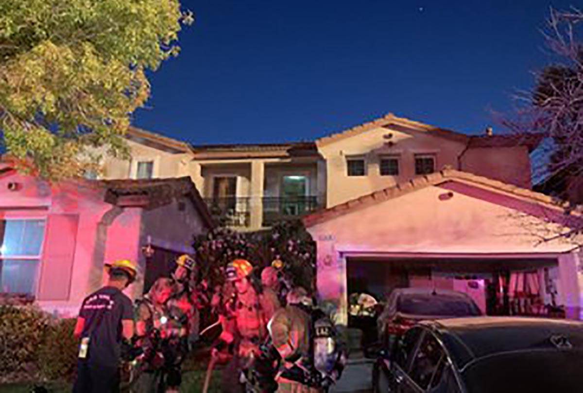 Firefighters outside 3436 Lacebark Pine St. in Las Vegas after a fire early Friday, Oct., 2, 20 ...