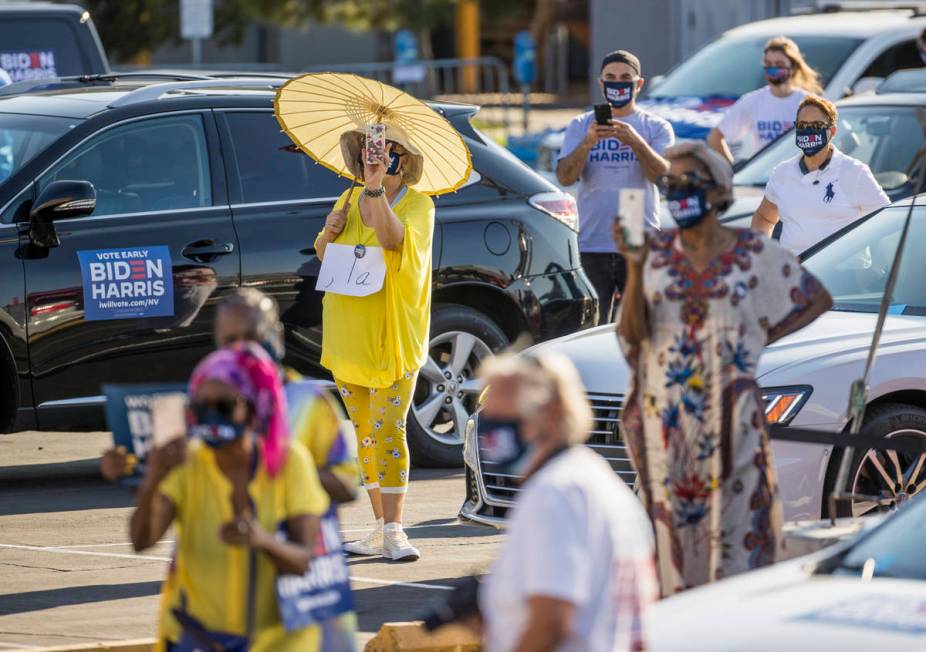 Attendees listen as Democratic vice presidential nominee Kamala Harris speaks about the importa ...