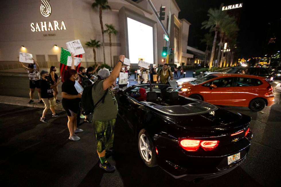Protesters stop traffic at Sahara Avenue while marching along Las Vegas Boulevard in memory of ...