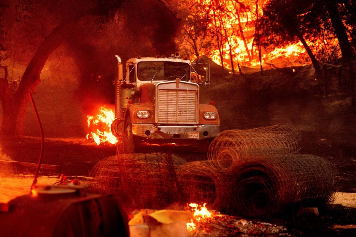 Flames from the Glass Fire burn a truck in a Calistoga, Calif., vineyard Thursday, Oct. 1, 2020 ...