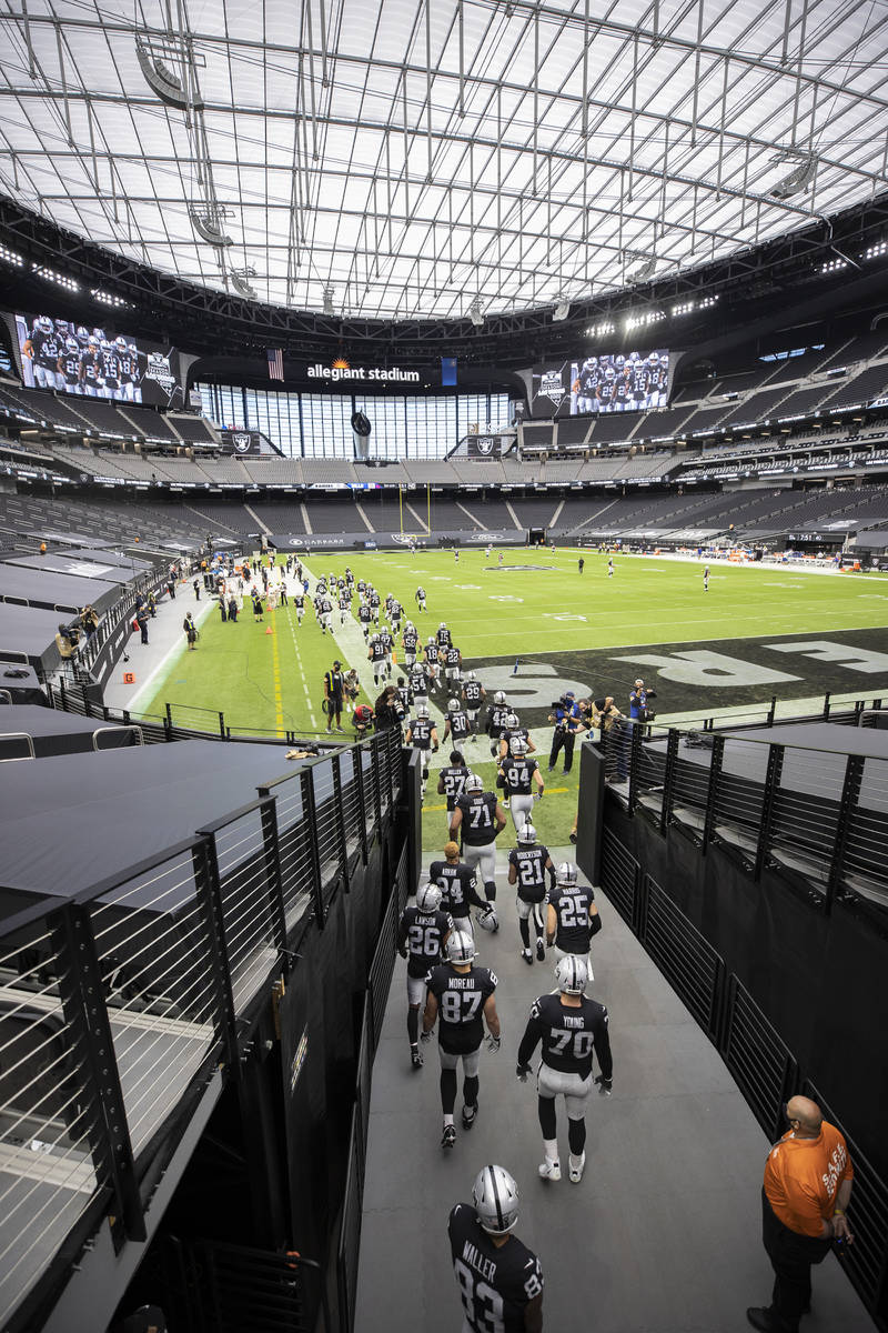 The Las Vegas Raiders take the field before the start of an NFL football game with the Buffalo ...