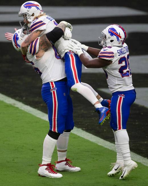 Buffalo Bills offensive guard Brian Winters and running back Devin Singletary (26) congratulate ...