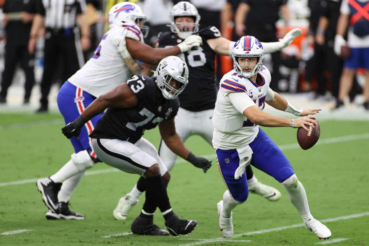 Buffalo Bills quarterback Josh Allen (17) is pressured by Las Vegas Raiders defensive tackle Ma ...