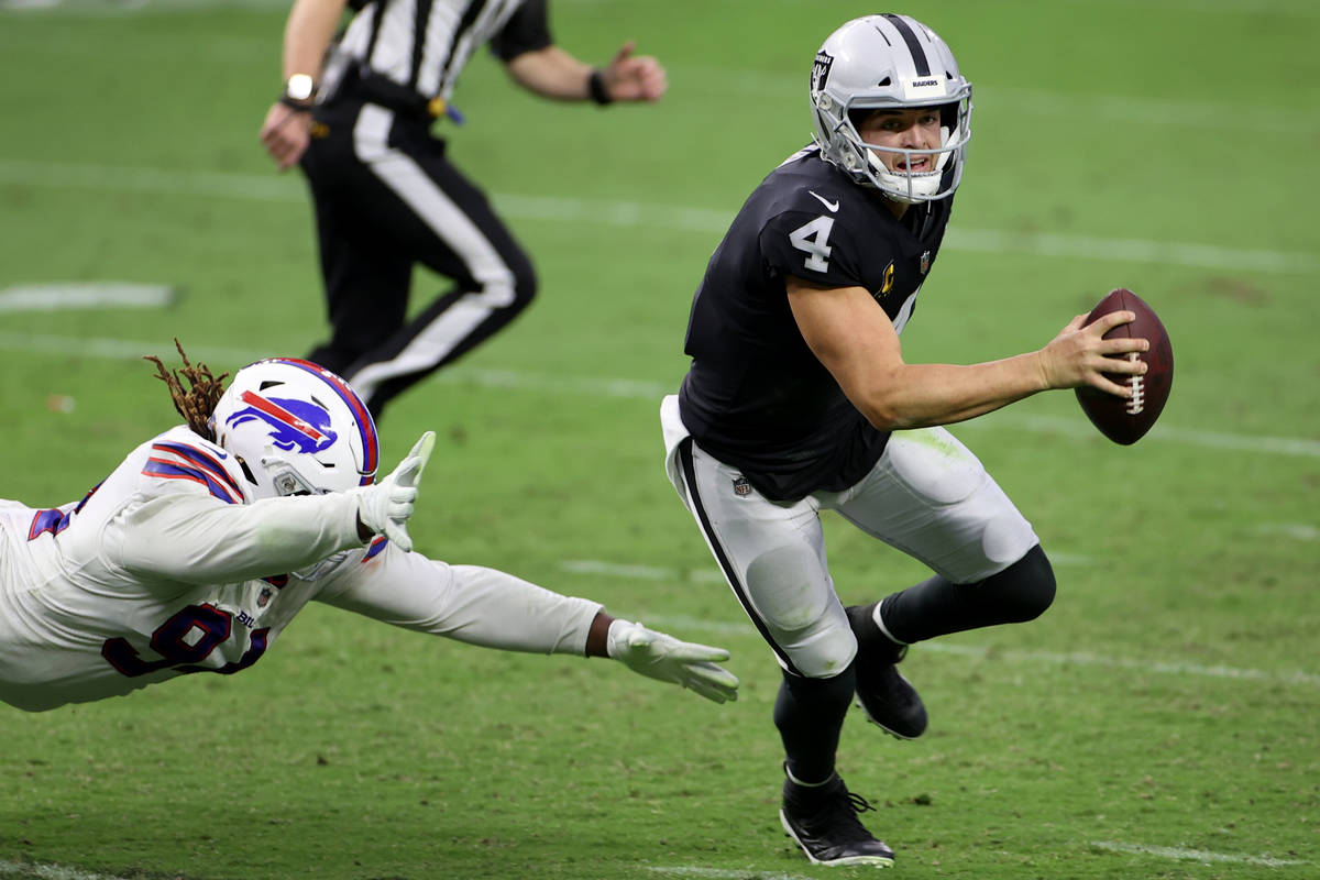 Las Vegas Raiders quarterback Derek Carr (4) is pressured by Buffalo Bills defensive tackle Ver ...