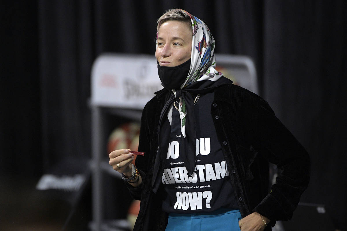 Professional soccer player Megan Rapinoe watches the first half of Game 2 of basketball's WNBA ...