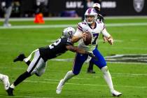Las Vegas Raiders cornerback Keisean Nixon (22) dives to tackle Buffalo Bills quarterback Josh ...
