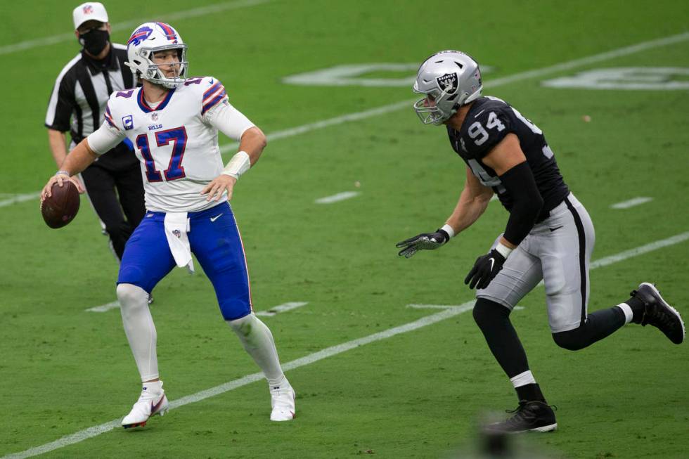 Las Vegas Raiders defensive end Carl Nassib (94) pressures Buffalo Bills quarterback Josh Allen ...